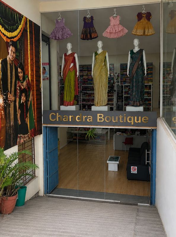 Tailor at Chandra Boutique hand-finishing a bridal blouse with aari embroidery in Kasturi Nagar, Bangalore